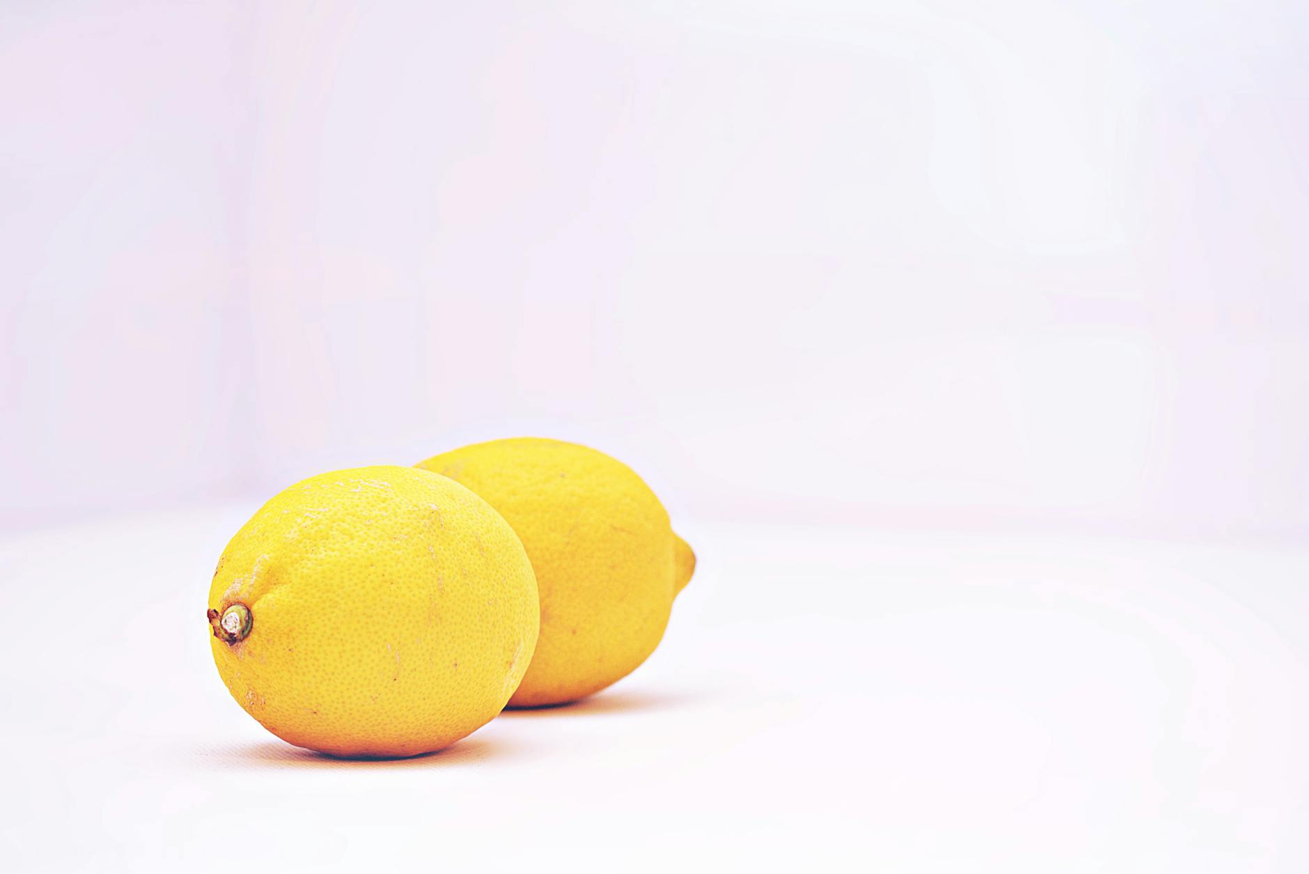Bright lemons on white background symbolizing freshness and new beginnings