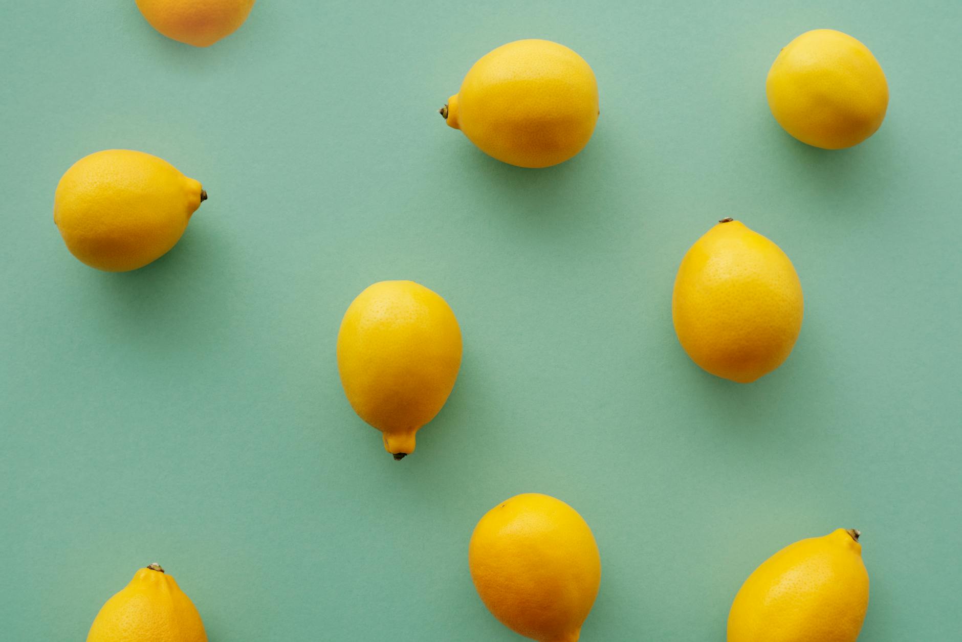 Fresh yellow lemons on a pastel green background, representing renewed arousal and sensory awakening