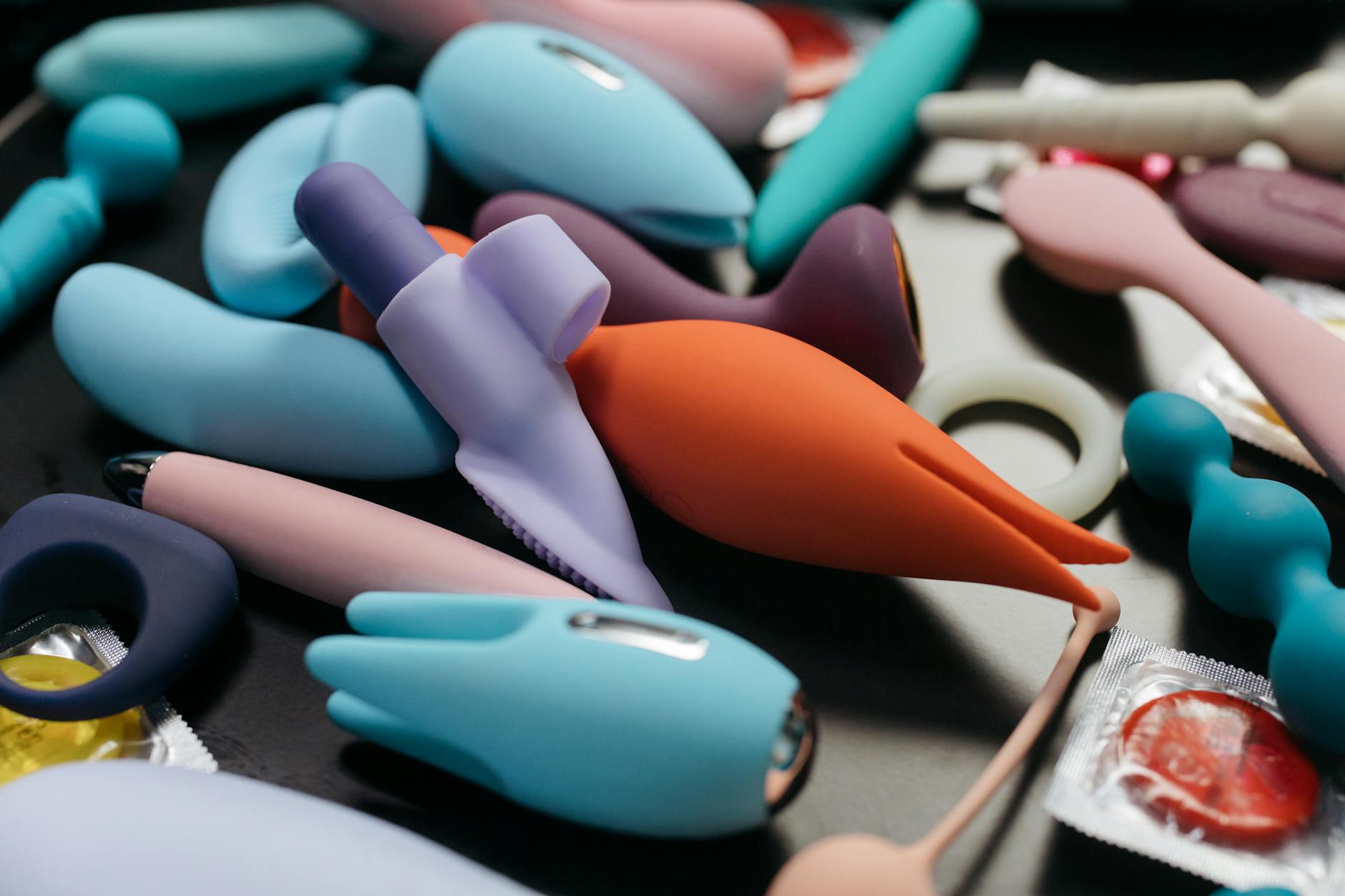 An array of vibrant adult toys including vibrators in a close-up view.