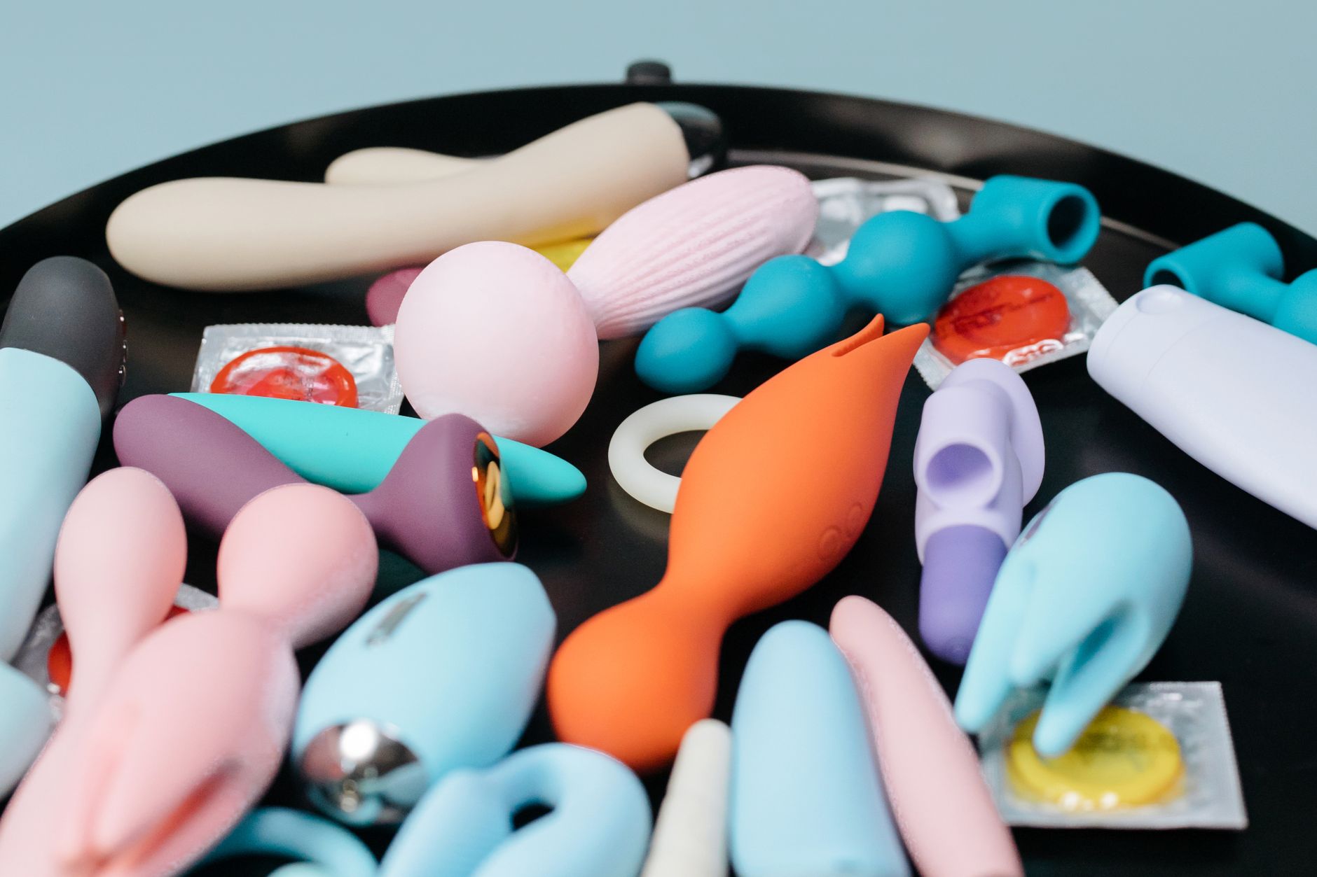Woman thoughtfully considering sexuality and pleasure with silicone vibrators