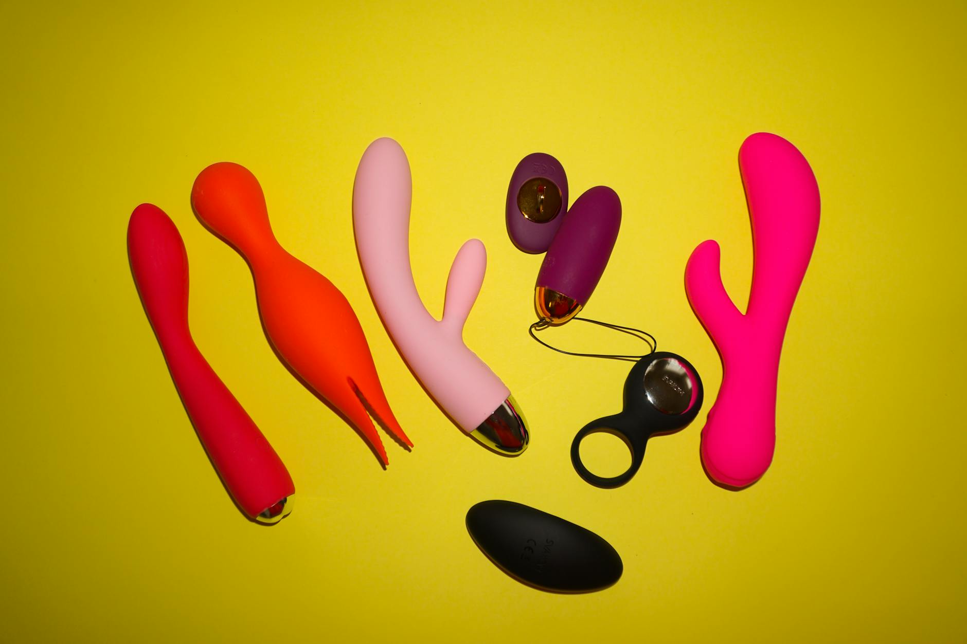 Bright yellow lemons arranged on a yellow background, representing the bold simplicity of Hello Nancy's Lemon vibrators